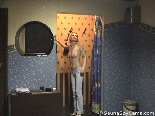 Voyeur cam shot of a topless blondie